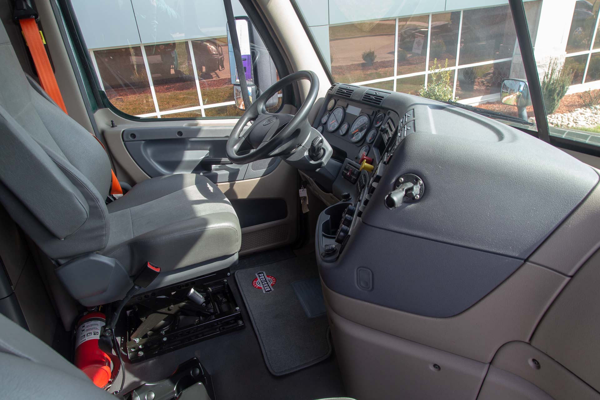 The interior cabin of a Freightliner semi-truck at Pedigree Truck & Trailer Sales.