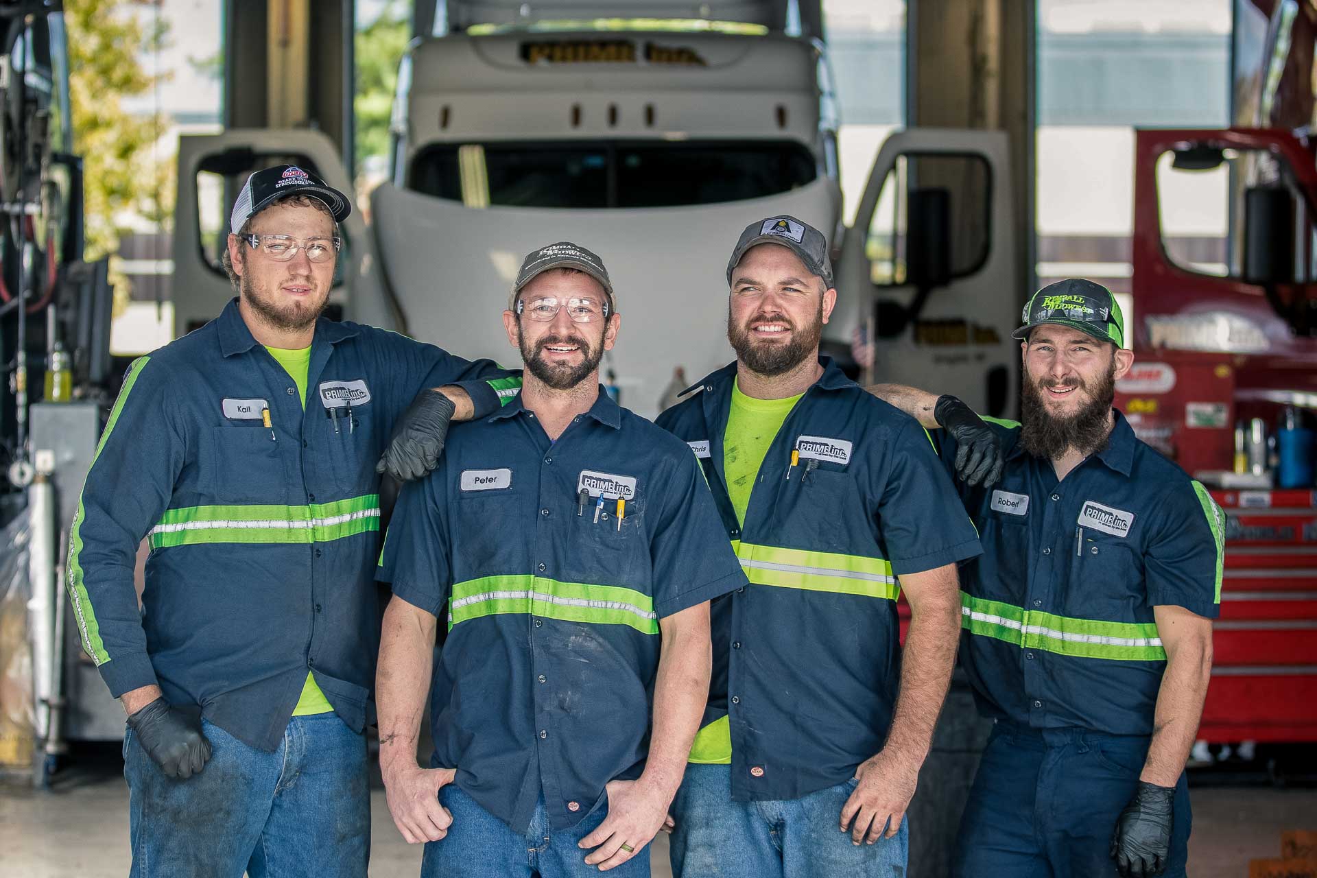 Four Prime Mechanic associates pose in the maintenance shop at Prime.