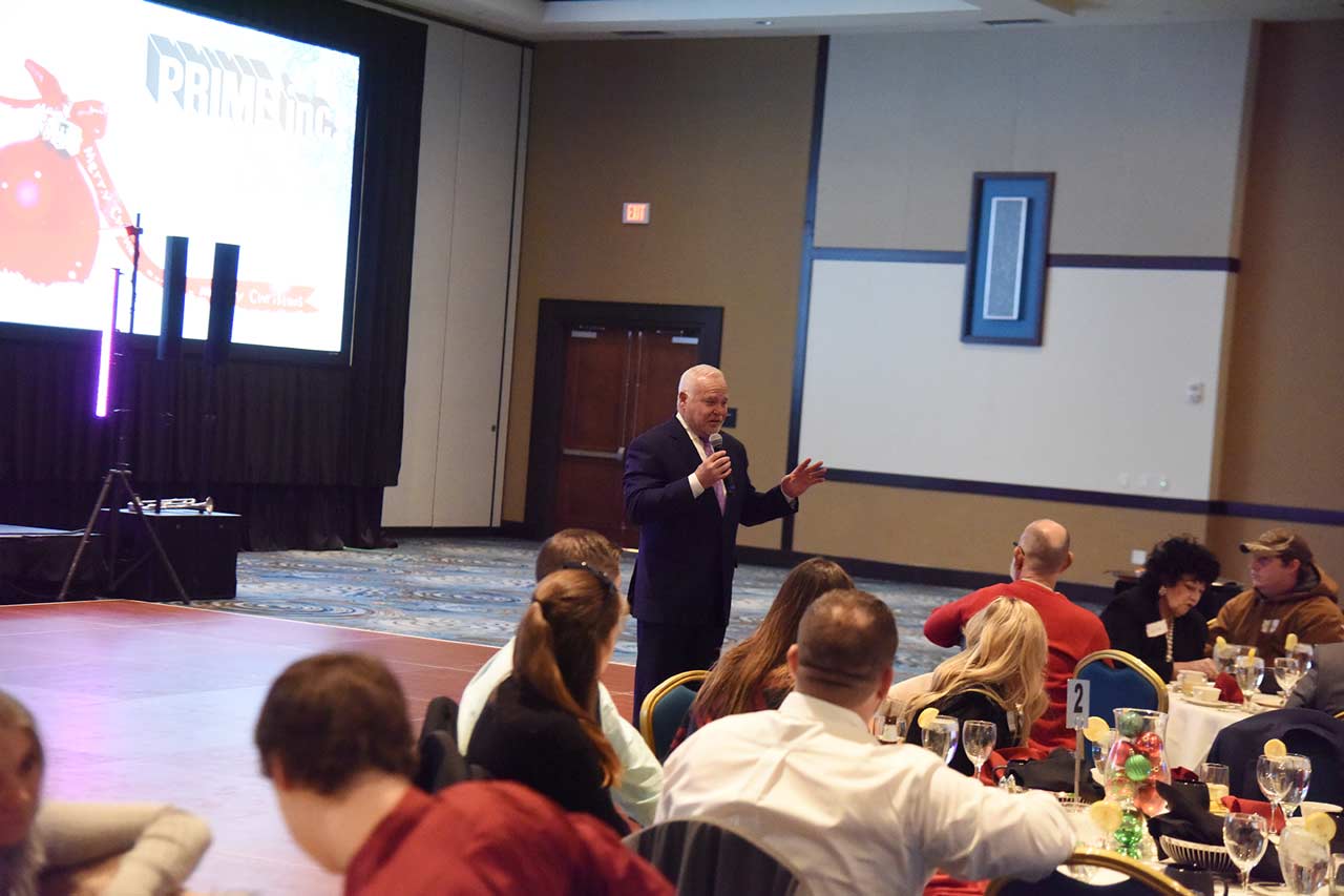 Robert Low, the founder of Prime, Inc., giving a speech at Prime's Annual Christmas Party.