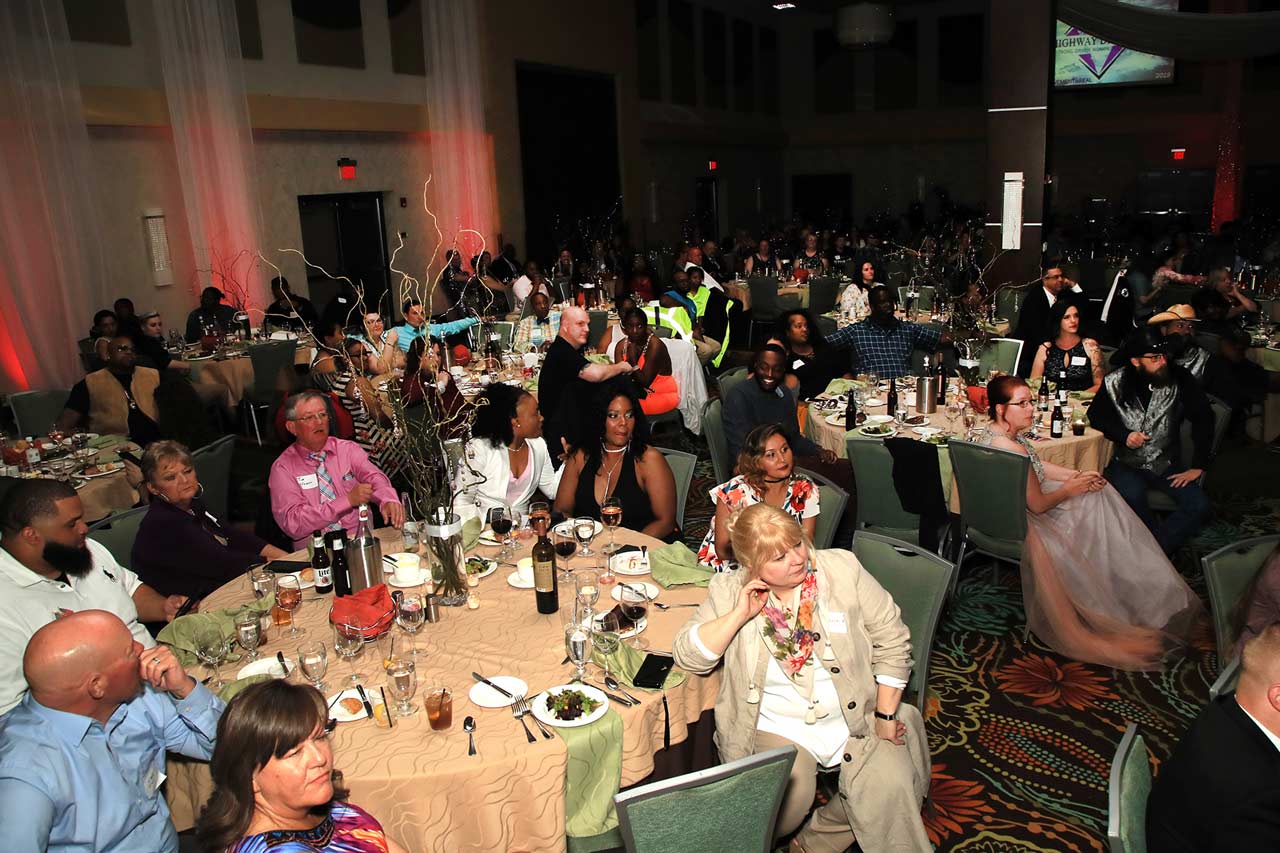 Female truck drivers and their families sitting in a ballroom, while being celebrated during Prime Inc,'s annual Highway Diamonds Gala.