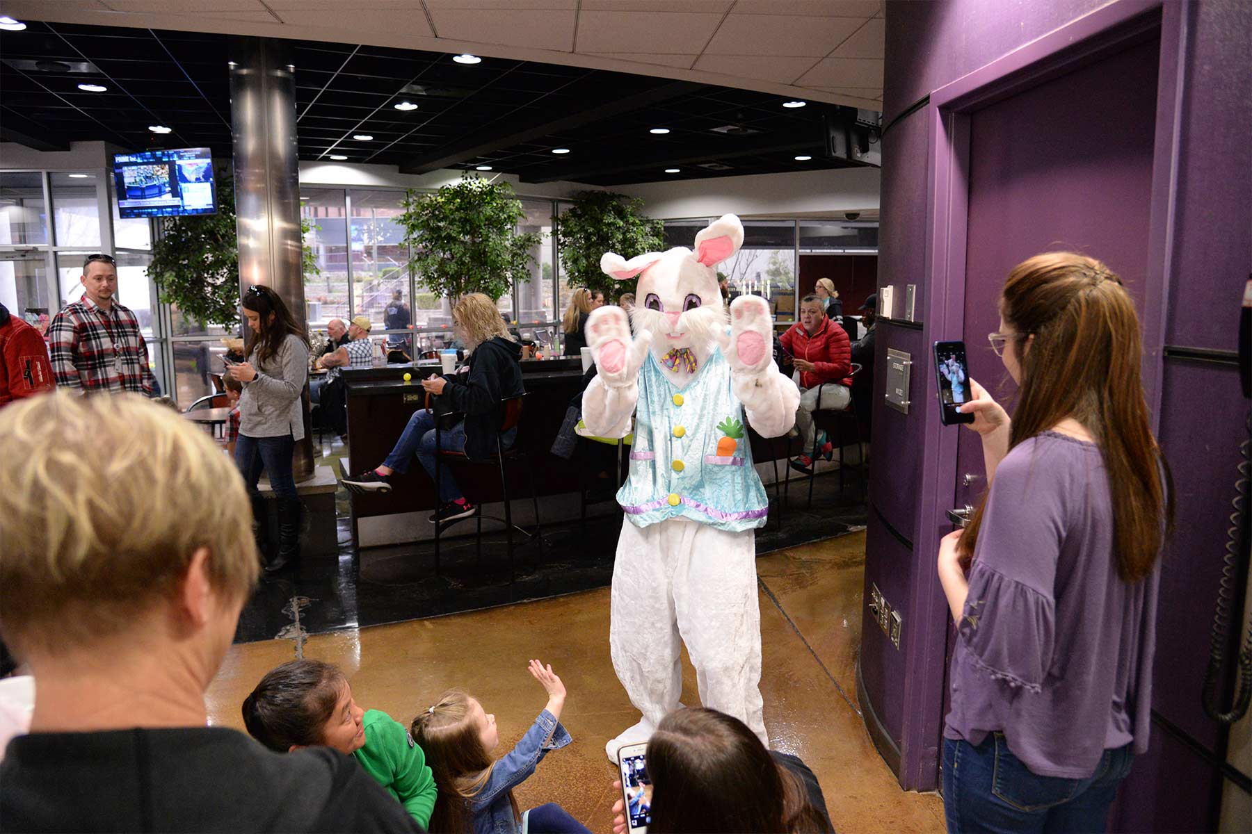 The Easter bunny greeting children and their parents during Prime Inc.'s annual Easter Egg Hunt.