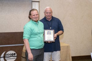 Julian Croft, one of Prime Inc.'s instructors of the year, standing next to founder Robert Low at the Top Instructor and Trainer banquet.