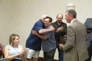 A couple of Prime Inc.'s truck driving instructors hugging before receiving an award at the Top Instructor and Trainer banquet.