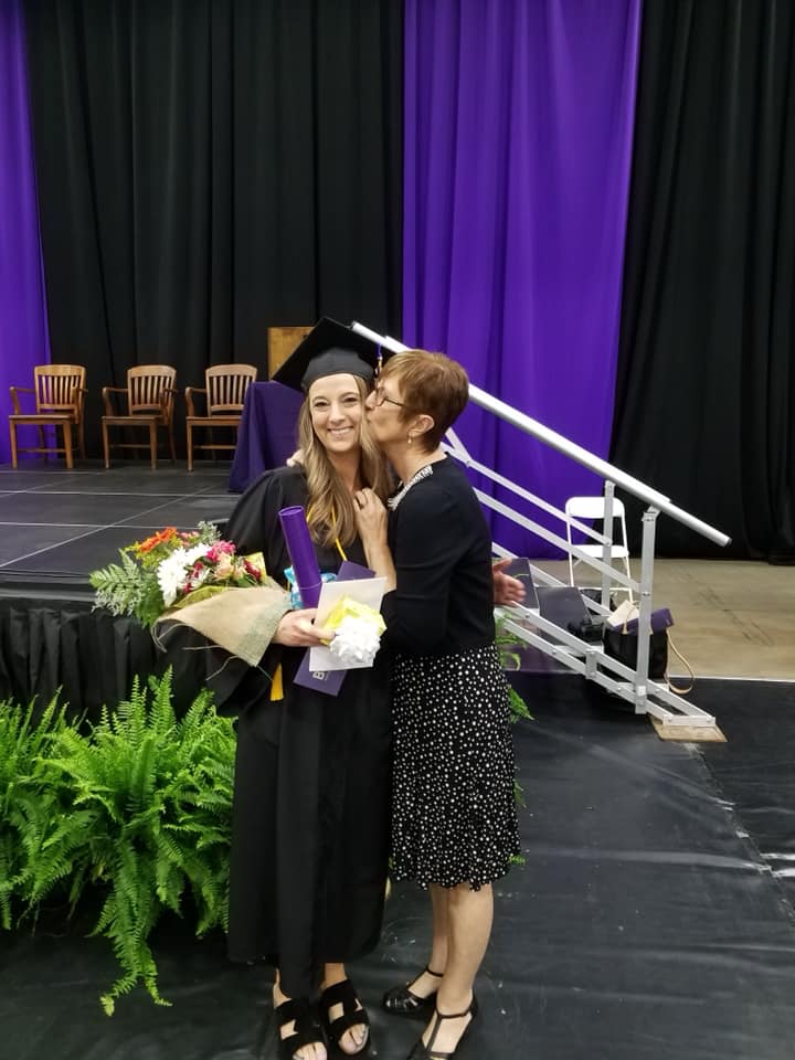 Hannah Dukewits, a participant of Prime's education assistance program, posing with her mom at graduation.