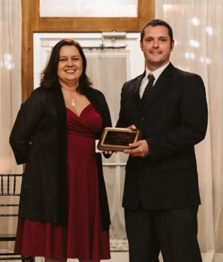 Picture of Jon Brown winning award 