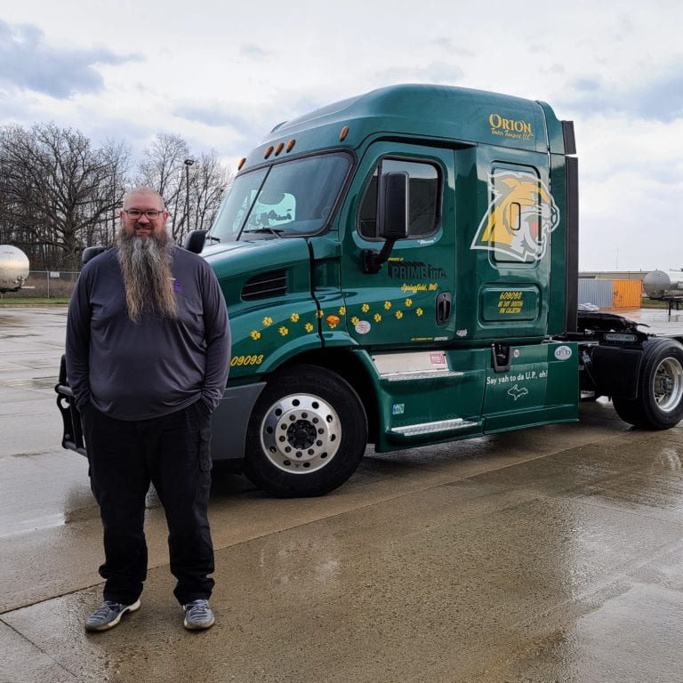 Prime Inc. Tanker Driver John Ogren in front of his green truck