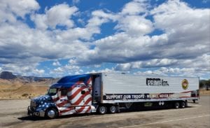 Custom semi-truck with American flag graphics.