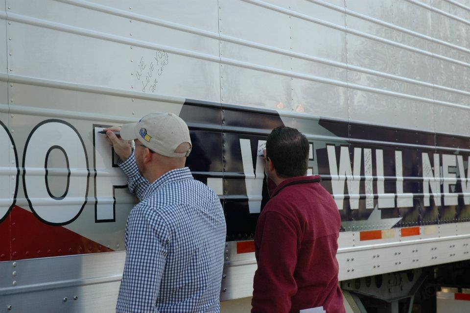 Veterans sign trailer for Wreaths Across America.