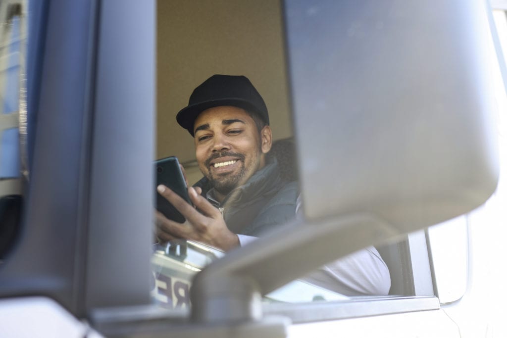 Truck driver using a mobile app.