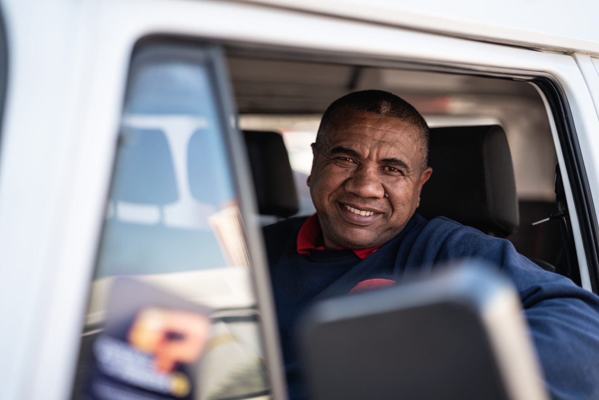 Portrait of a mature truck driver behind the wheel of his cab